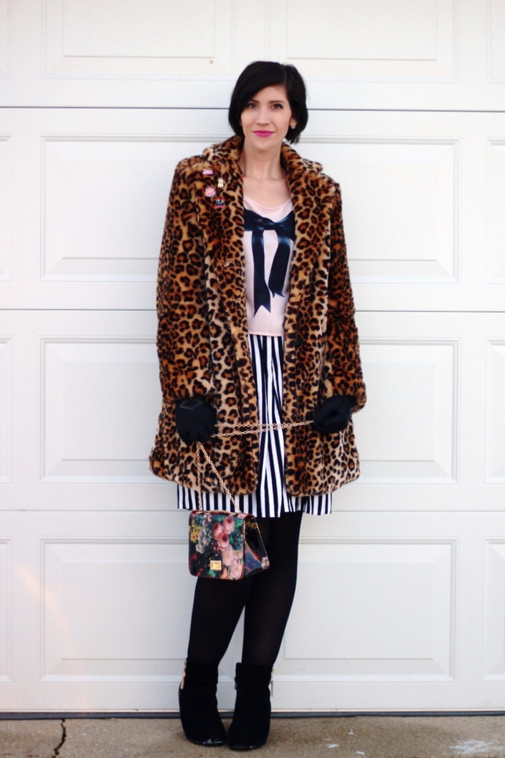 Outfit: leopard print coat, cool enamel pins, graphic bow tee, black and white striped skirt, black tights, black booties, floral print purse