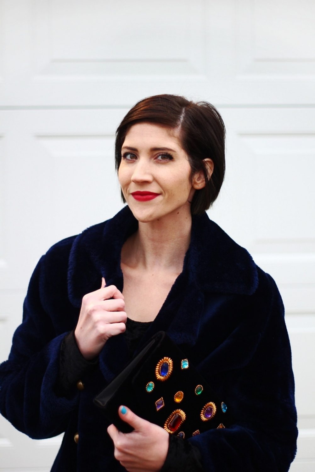 Outfit: little black dress, faux fur navy blue coat, embellished clutch