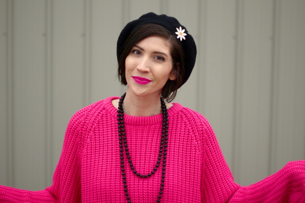 Oversized pink sweater, vintage beaded necklace, black beret, daisy pin