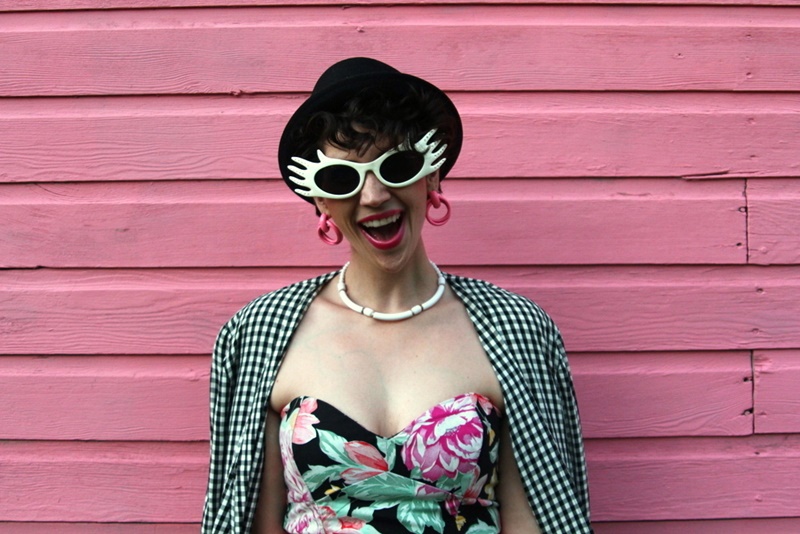 80s style floral prom dress, footless tights, pink belt, gingham jacket, pork pie hat, doorknocker earrings, quilted purse, white sunglasses, socks with heels