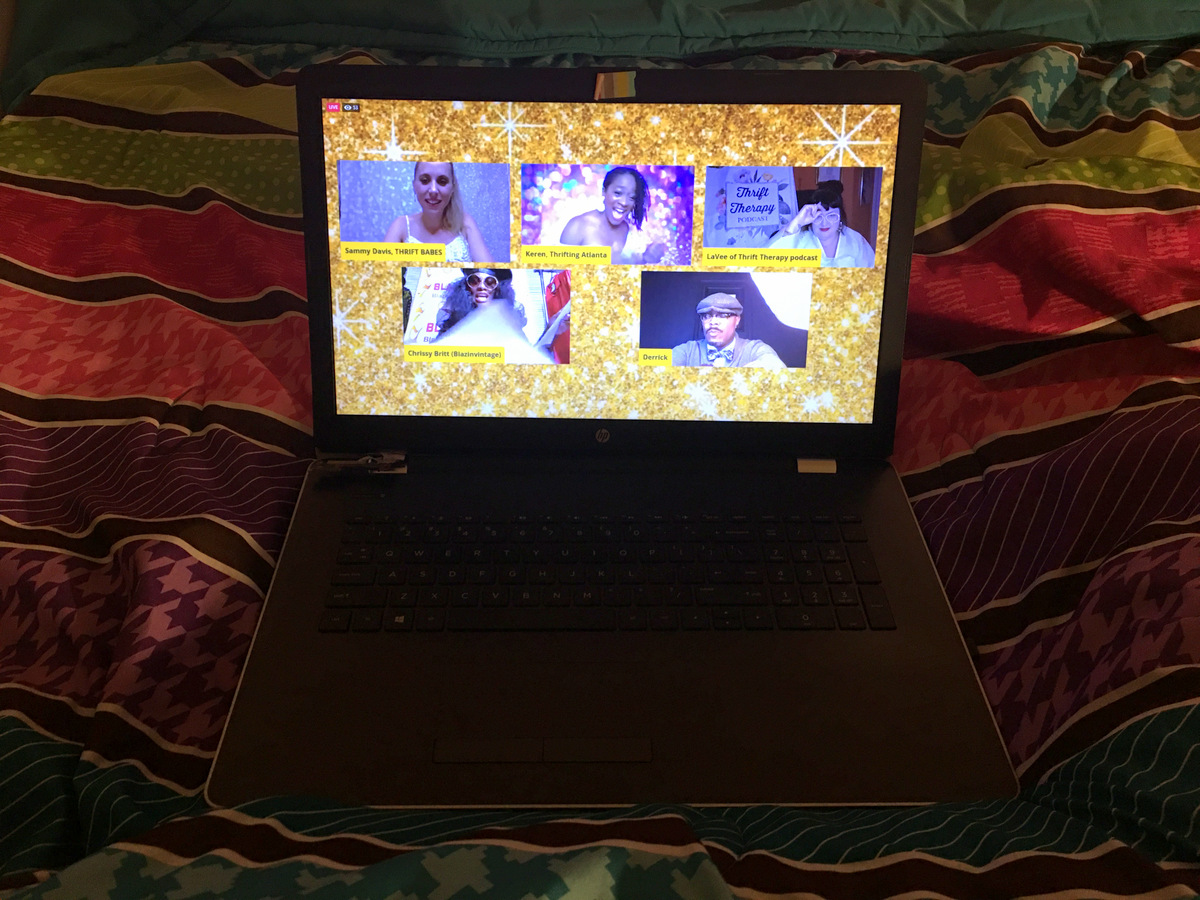Everything You Missed At The First Heart of Thrift Conference | theoutfitrepeater.com a laptop on a colorful bed comforter displaying a still from a live video during the Heart of Thrift Conference 2020