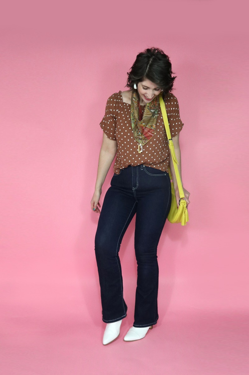 best thrifted clothes high waisted dark wash flared jeans polka dot top yellow purse outfit