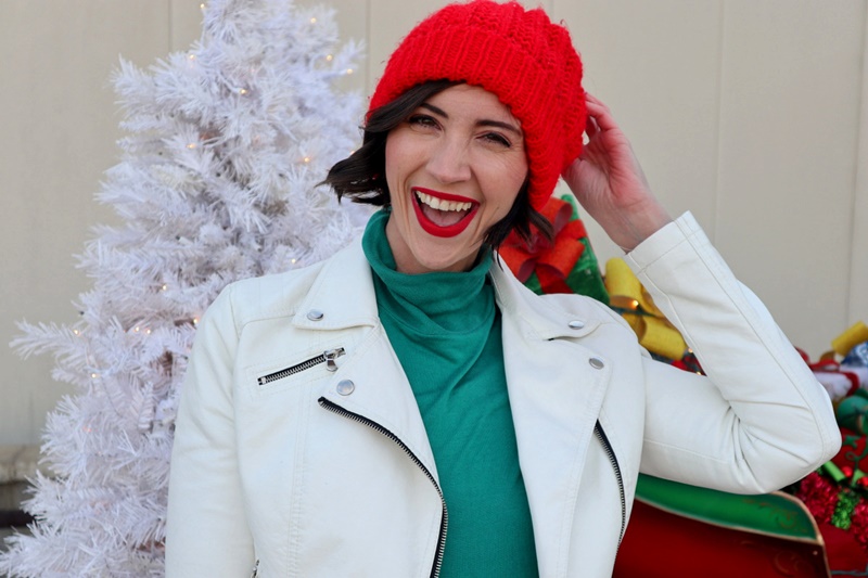 thrifted christmas outfit, green turtleneck, thredup white moto jacket, red beanie hat