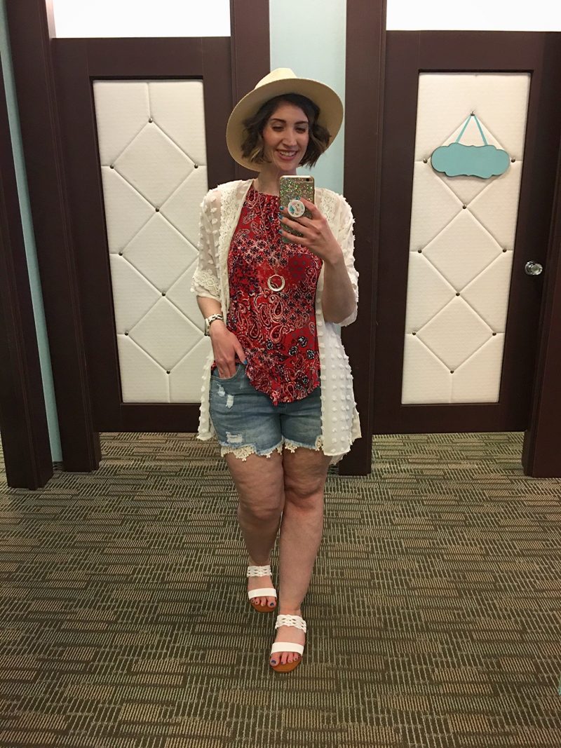 Outfit Photo Dump: What I Wore At Work (In A Clothing Store!) | www.theoutfitrepeater.com hannah is standing in front of a mirror. she's wearing a red paisley tank top, white lace kimono, sun hair, lacy shorts, and white sandals