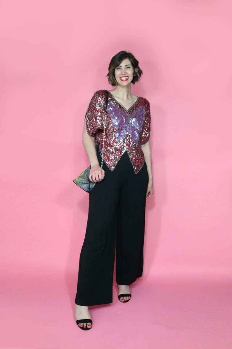 hannah is wearing a purple & red 1980s vintage sequined butterfly blouse