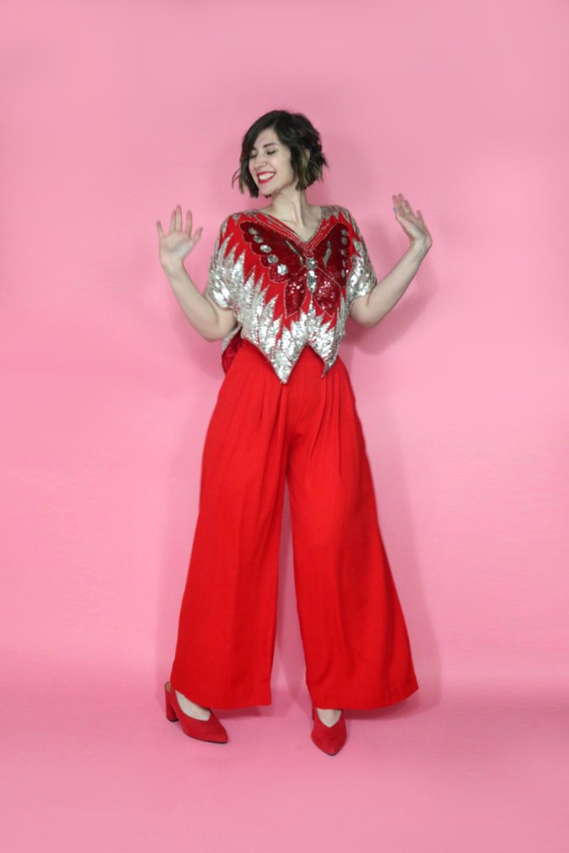 hannah is wearing a red 1980s vintage sequined butterfly blouse
