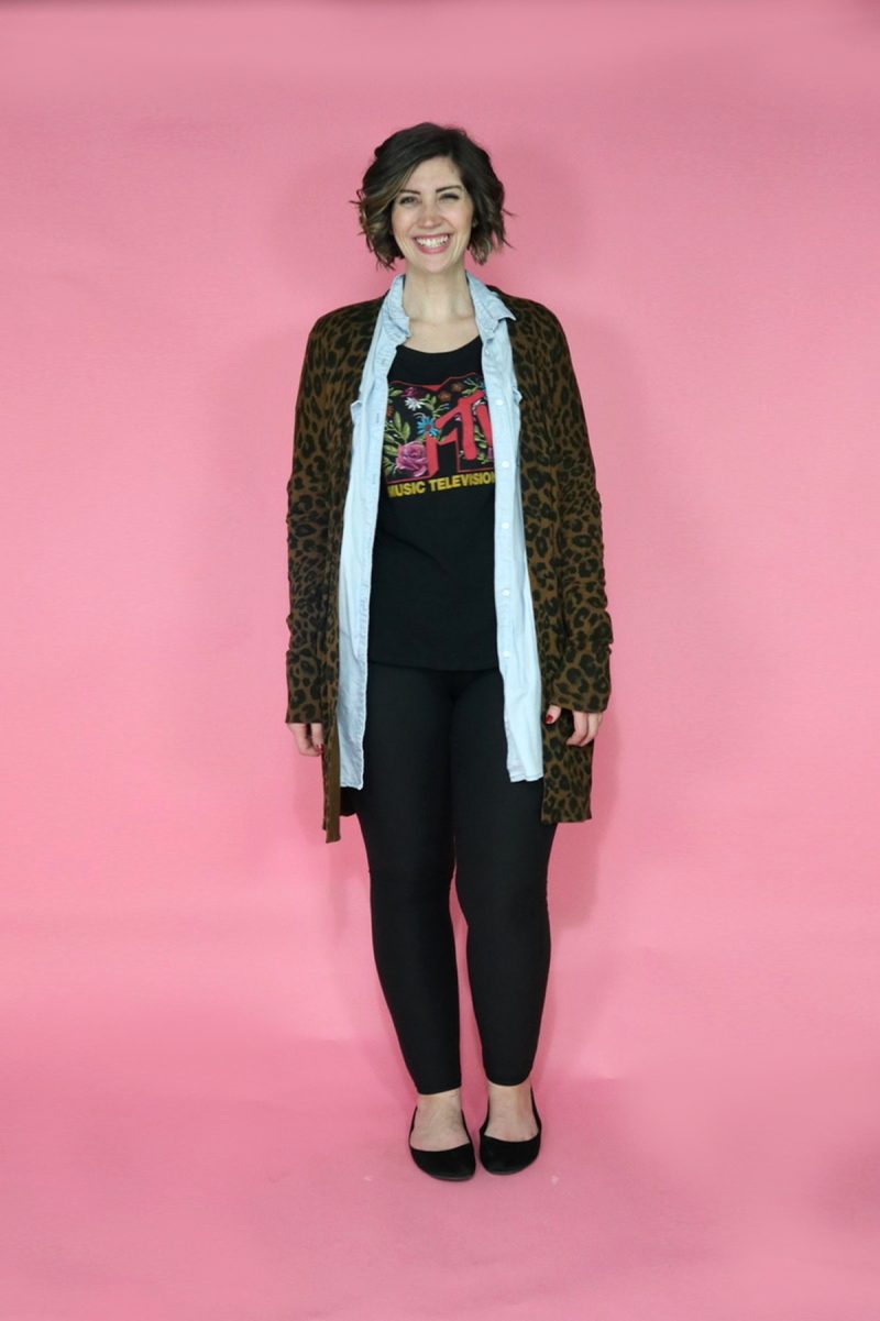 TikTok Outfit Challenge: My Followers Pick My Outfit For 1 Week | theoutfitrepeater.com hannah is smiling wearing a graphic tee, chambray tunic, leopard print cardigan, and black leggings