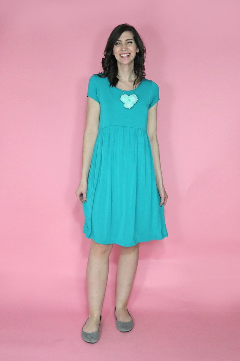 10 Essential Outfits You Should Always Have In Your Closet | theoutfitrepeater.com smiling white female with mid-length brown hair, teal dress, and ballet flats